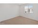 Bedroom with a window bringing in natural light and neutral carpeting at 2121 W Sonoran Desert Dr # 14, Phoenix, AZ 85085