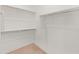 Walk-in closet with ample shelving and neutral carpeting at 2121 W Sonoran Desert Dr # 14, Phoenix, AZ 85085