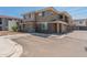 Neutral-toned home showcasing stonework accents, well-maintained landscaping, and convenient parking at 2121 W Sonoran Desert Dr # 14, Phoenix, AZ 85085