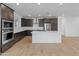 Modern kitchen with sleek dark cabinets, stainless steel appliances, subway tile backsplash, and a large white island at 2121 W Sonoran Desert Dr # 14, Phoenix, AZ 85085