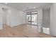 Light-filled living room boasting wood-look tile flooring, white walls, and sliding glass doors to the balcony at 2121 W Sonoran Desert Dr # 14, Phoenix, AZ 85085