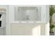 Modern bathroom with a double vanity, large mirror, and pristine white cabinetry at 24971 N 167Th Dr, Surprise, AZ 85387