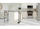 Well-equipped kitchen featuring stainless steel appliances, breakfast bar, and seamless white cabinetry at 24971 N 167Th Dr, Surprise, AZ 85387
