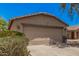 A front exterior of a single-story home featuring a 2 car garage and desert landscaping at 2516 E San Manuel Rd, San Tan Valley, AZ 85143