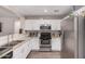 Bright kitchen with stainless steel appliances, white cabinets and granite countertops offering a modern design at 2516 E San Manuel Rd, San Tan Valley, AZ 85143