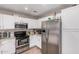 Well-lit kitchen featuring stainless steel appliances, granite countertops and white cabinetry for a modern feel at 2516 E San Manuel Rd, San Tan Valley, AZ 85143