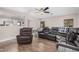 View of living room with hardwood floors, a ceiling fan, and a large sectional couch at 2516 E San Manuel Rd, San Tan Valley, AZ 85143
