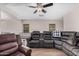 Open living room featuring hardwood floors, a ceiling fan, and a comfortable looking sectional couch at 2516 E San Manuel Rd, San Tan Valley, AZ 85143