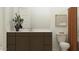 Bathroom with brown cabinets, framed art and a large mirror at 25233 N 177Th Dr, Surprise, AZ 85387