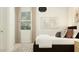 Modern bedroom with large window, accent pillows, and a patterned rug at 25233 N 177Th Dr, Surprise, AZ 85387