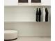 Walk-in closet with an ottoman and baskets above the hanging rods at 25233 N 177Th Dr, Surprise, AZ 85387