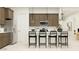 Modern kitchen featuring stainless steel appliances, sleek cabinetry, and a breakfast bar with seating at 25233 N 177Th Dr, Surprise, AZ 85387