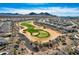 Panoramic aerial view of homes surrounding a scenic golf course with mountains in the background at 25979 W Taro Dr, Buckeye, AZ 85396