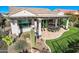 Spacious backyard featuring a covered patio, well-maintained artificial lawn, and desert landscaping at 25979 W Taro Dr, Buckeye, AZ 85396