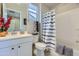 Bright bathroom featuring a shower-tub combo, a toilet, and a single sink vanity at 25979 W Taro Dr, Buckeye, AZ 85396