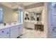 Bright and spacious bathroom featuring double sinks, vanity area, and a walk-in shower with marble accents at 25979 W Taro Dr, Buckeye, AZ 85396