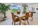 Bright dining room featuring a wooden table, comfortable chairs, and a window with serene outdoor views at 25979 W Taro Dr, Buckeye, AZ 85396
