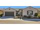 Beautiful home featuring desert landscaping, tile roofing, and a two-car garage at 25979 W Taro Dr, Buckeye, AZ 85396