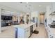 Modern kitchen featuring stainless steel appliances, a large island, pendant lighting, and an open floor plan at 25979 W Taro Dr, Buckeye, AZ 85396