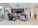 Living room featuring a tv, entertainment center, tile floors, comfortable seating, and large sliding glass doors at 25979 W Taro Dr, Buckeye, AZ 85396