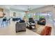 Bright living room featuring tile flooring, a ceiling fan, modern furniture and multiple windows with outdoor views at 25979 W Taro Dr, Buckeye, AZ 85396