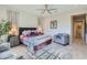 A calm primary bedroom features soft lighting, a decorative area rug, and contemporary furnishings at 25979 W Taro Dr, Buckeye, AZ 85396