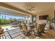 Covered outdoor patio with comfortable seating area and a view of the mountains beyond at 25979 W Taro Dr, Buckeye, AZ 85396
