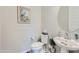 Well-lit powder room with a pedestal sink, stylish fixtures, and modern finishes for a refreshing experience at 25979 W Taro Dr, Buckeye, AZ 85396