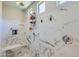 Modern shower features white marble, rainfall shower head, built-in bench, and recessed niche for toiletries at 25979 W Taro Dr, Buckeye, AZ 85396