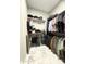 Well-organized walk-in closet with ample hanging space and shelving for efficient storage and marble floor at 25979 W Taro Dr, Buckeye, AZ 85396