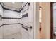Walk-in shower featuring subway tile with a decorative stripe and bronze hardware at 2602 S 226Th Dr, Buckeye, AZ 85326