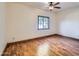 Bedroom featuring hardwood floors, a ceiling fan, and a window with natural light at 2602 S 226Th Dr, Buckeye, AZ 85326