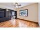 Bedroom with hardwood floors, a ceiling fan, and a large window at 2602 S 226Th Dr, Buckeye, AZ 85326