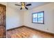 Bedroom featuring hardwood floors, ceiling fan, and a window with natural light at 2602 S 226Th Dr, Buckeye, AZ 85326