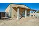 Charming home exterior with covered patio and seating area at 2602 S 226Th Dr, Buckeye, AZ 85326