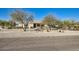 Single story home featuring desert landscaping and mature trees on a large lot at 2602 S 226Th Dr, Buckeye, AZ 85326