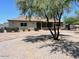 Inviting single-story home featuring desert landscaping and a circular brick-paved driveway at 2602 S 226Th Dr, Buckeye, AZ 85326