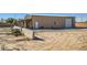 Property view showcasing an outbuilding and desert landscape at 2602 S 226Th Dr, Buckeye, AZ 85326