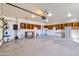 Garage featuring a large space with overhead lighting, wooden shelving, and garage door at 2602 S 226Th Dr, Buckeye, AZ 85326