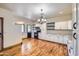 Large kitchen with white cabinets, hardwood floors, modern appliances, and ample counter space at 2602 S 226Th Dr, Buckeye, AZ 85326