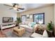 Cozy living room features a plush sofa, wood accents, and natural light at 2602 S 226Th Dr, Buckeye, AZ 85326