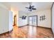 Bright living room showcasing hardwood floors, a ceiling fan, and french doors to the outside at 2602 S 226Th Dr, Buckeye, AZ 85326