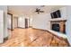 Spacious living room featuring hardwood floors, a fireplace, and neutral wall colors at 2602 S 226Th Dr, Buckeye, AZ 85326