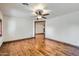 Open-concept living room featuring hardwood floors, ceiling fan and natural light at 2602 S 226Th Dr, Buckeye, AZ 85326