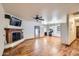 Open-concept living room featuring hardwood floors, a fireplace, and an eat-in kitchen area at 2602 S 226Th Dr, Buckeye, AZ 85326