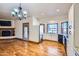 Open-concept living area with hardwood floors and an adjacent updated kitchen at 2602 S 226Th Dr, Buckeye, AZ 85326