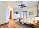 Bright main bedroom with french doors, ceiling fan, and wood-look flooring at 2602 S 226Th Dr, Buckeye, AZ 85326