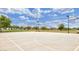 Outdoor basketball court in a community with well-manicured lawns and lush green trees underneath a blue sky at 2670 E Bellerive Dr, Gilbert, AZ 85298