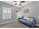 Bedroom with a blue sofa, shuttered window, and calming decor at 2670 E Bellerive Dr, Gilbert, AZ 85298