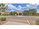 Community building featuring stone facade, mature trees, and well-manicured landscaping at 2670 E Bellerive Dr, Gilbert, AZ 85298